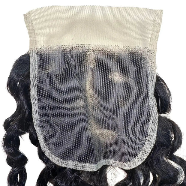 Spanish Wave 4x4 transparent lace human hair closure by THE HAIR PUSHER PREMIUM LUXE HAIR, showcasing curly, natural-looking hair extension.