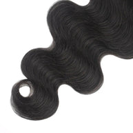 Body wave 5x5 transparent lace human hair closure from THE HAIR PUSHER PREMIUM LUXE HAIR, showing the lace and wavy hair texture.