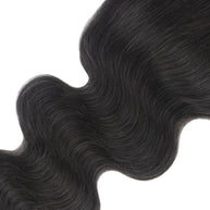 Body wave 5x5 transparent lace human hair closure from THE HAIR PUSHER PREMIUM LUXE HAIR, showing textured hair extension with lace closure