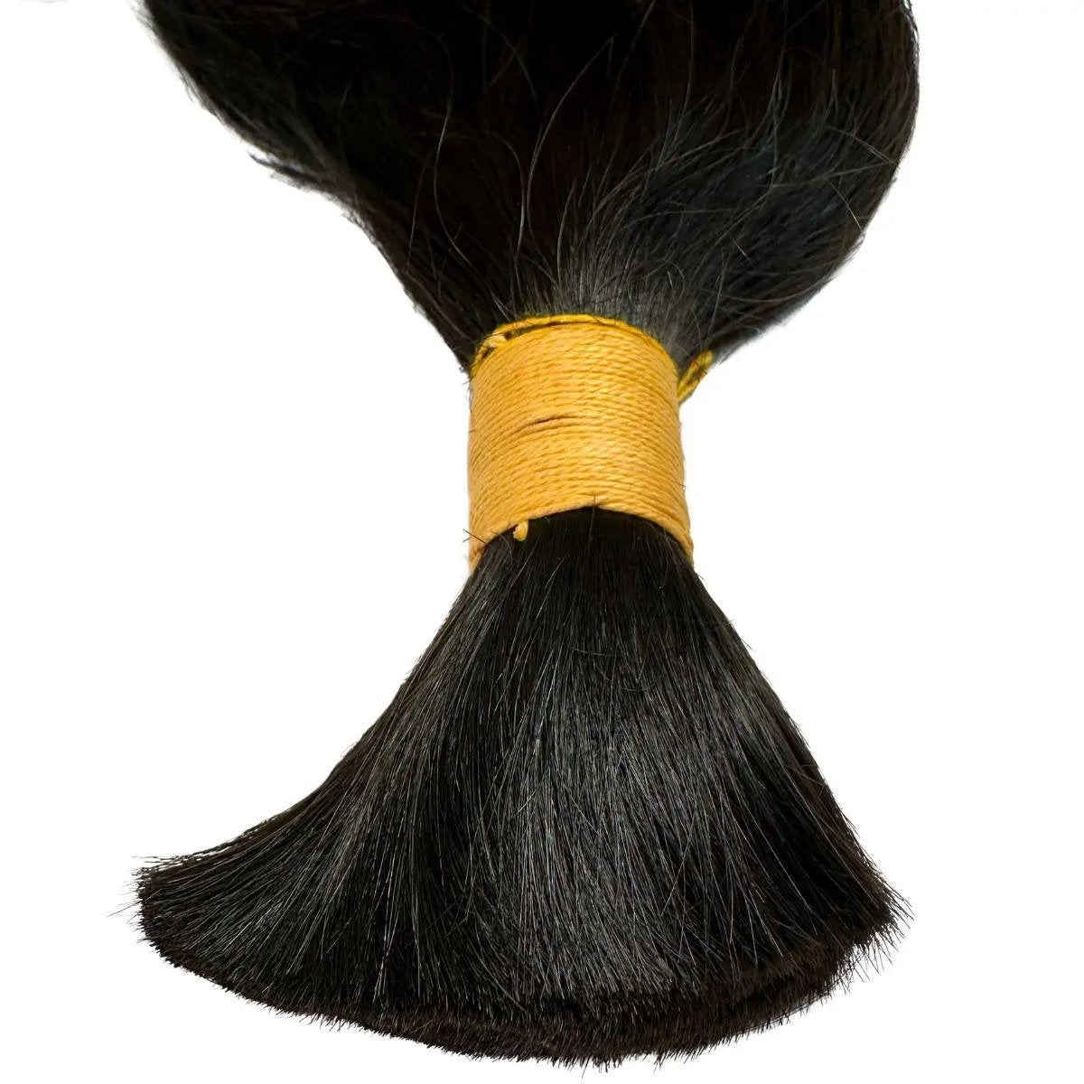 Close-up of raw Indian wavy human braiding hair extensions from THE HAIR PUSHER PREMIUM LUXE HAIR, showing natural texture and color