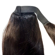 Natural black 100% human hair ponytail extension from THE HAIR PUSHER PREMIUM LUXE HAIR, showing smooth, shiny hair gathered in a ponytail.
